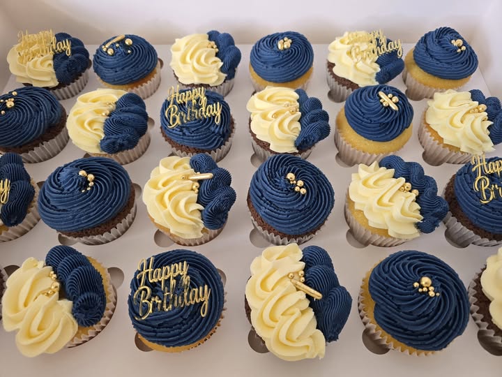 Gold mirror acrylic Happy Birthday cupcake charms displayed on blue and white iced cupcakes