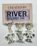 Whimsical baby animal edible wafer paper cake charms including a deer, fox, lion, elephant, rhino and panda arranged below a Riverside Stubby Co wooden sign
