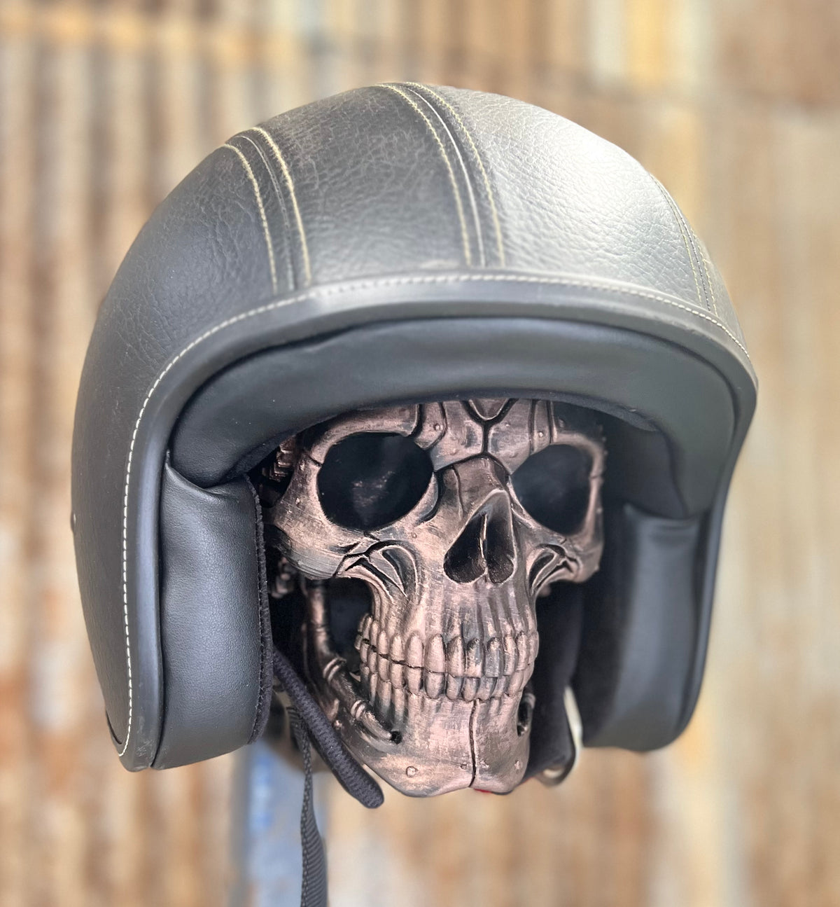 Motorcycle helmet displayed on a 3D printed steampunk skull helmet stand