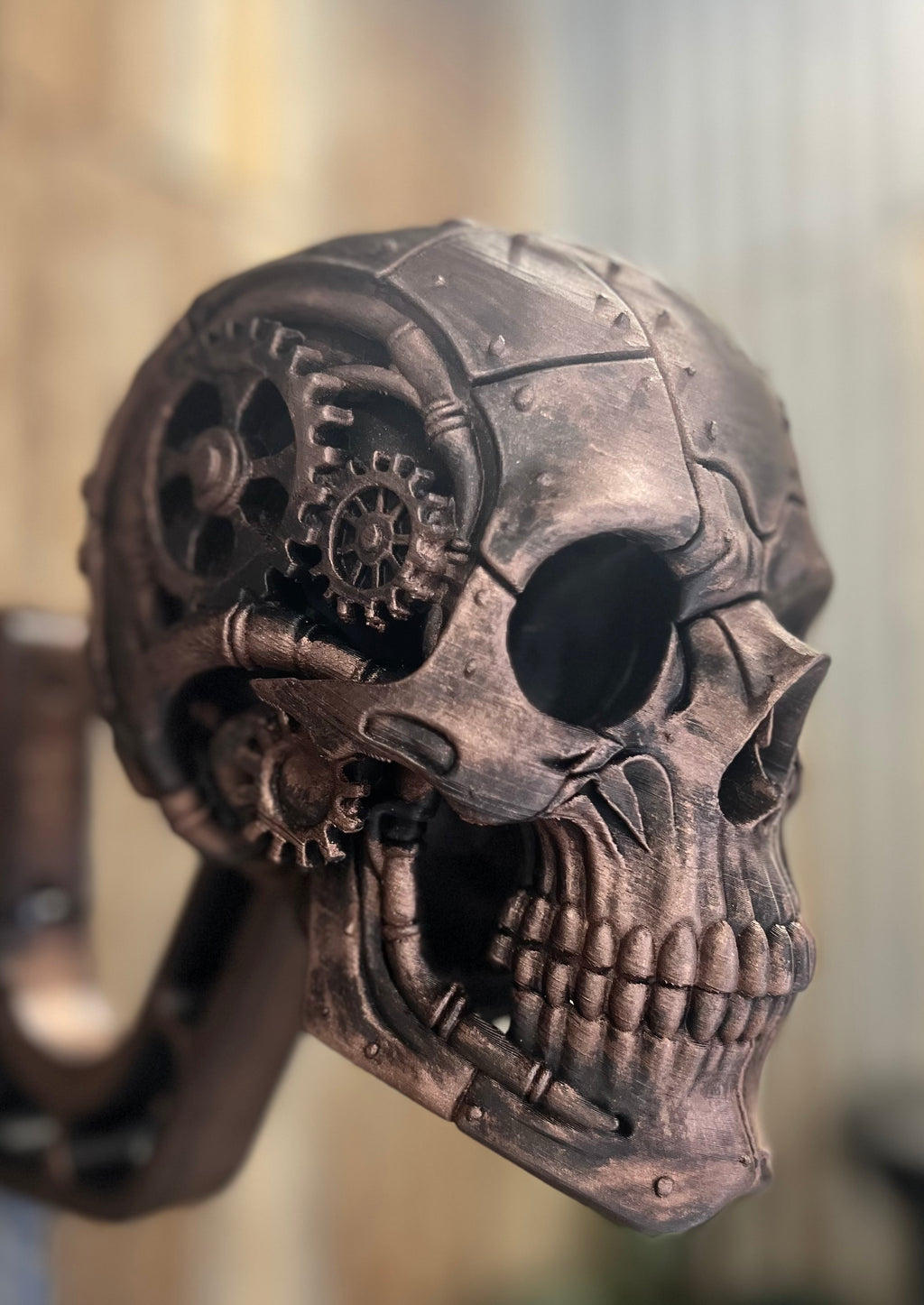 Side view of 3D printed steampunk helmet stand showing detailed gears and mechanical features